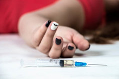 young girl passed out next to a heroin needle
