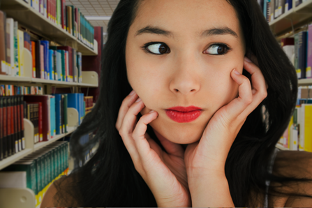Girl in library is apprehensive about whether or not she will find someone using drugs. 