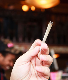 hand with a marijuana joint