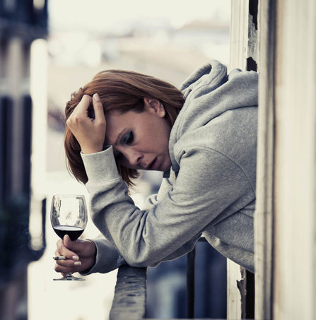 sad and depressed woman drinking alcohol