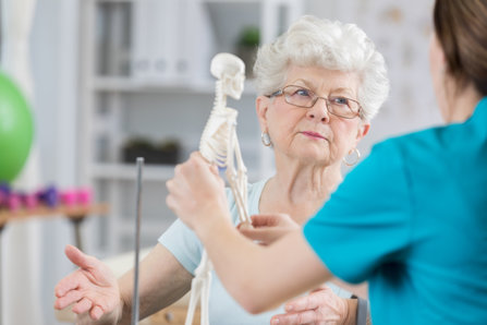 An Older woman seeing a doctor about osteoporosis