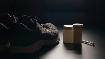 athletes shoes beside prescription drugs