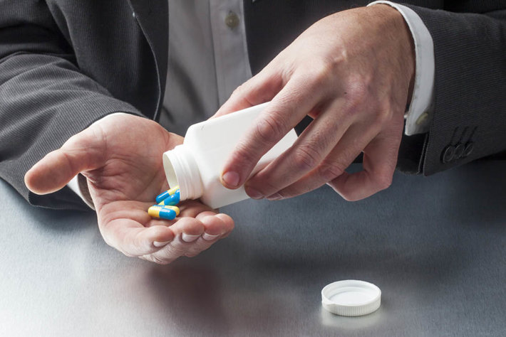 businessman taking pills